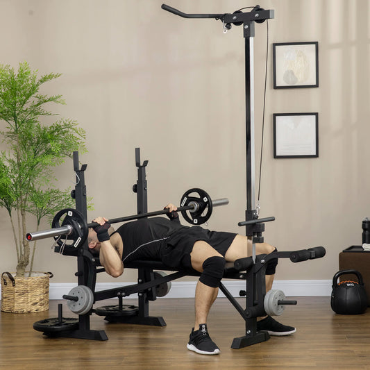 A person trains at home with the JB Muscle HOMCOM Multi Station Exercise Bench, lifting a barbell and using features like butterfly curl, lat pulldown, and leg curl on a wooden floor amid gym equipment.