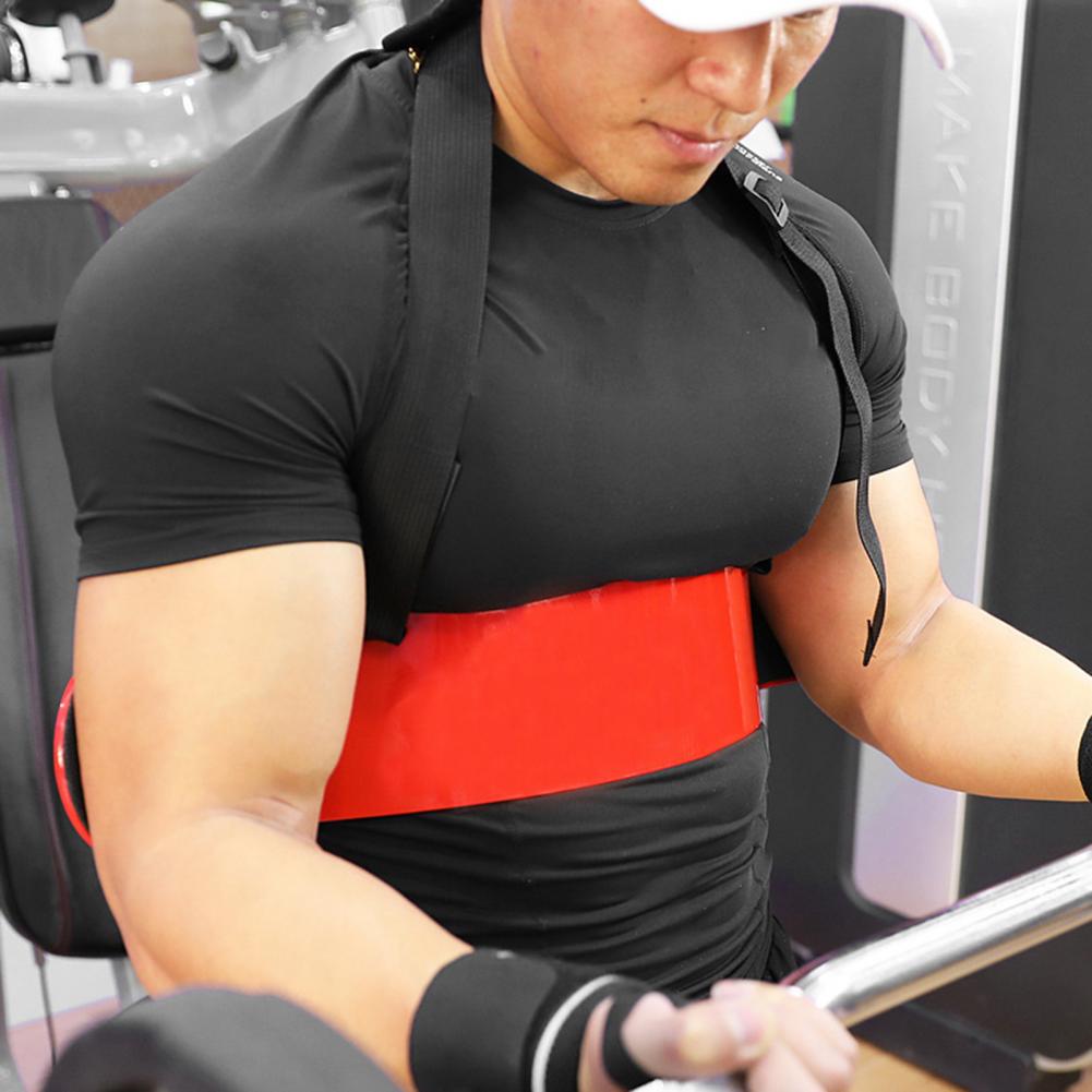 A person wearing a black shirt and using a red resistance band is performing bicep curls with a barbell at the gym, utilizing the JB Muscle™ Arm Blaster: Bicep Isolator to maximize bicep growth.