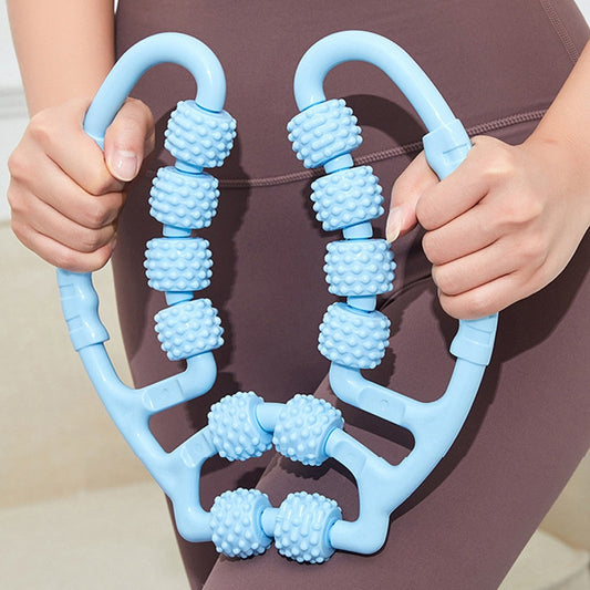 A person holding a blue JB Muscle™ Leg Clamp Massager: Relaxing Roller for Yoga, with textured knobs, stands poised to elevate their yoga practice and enhance their relaxation experience.