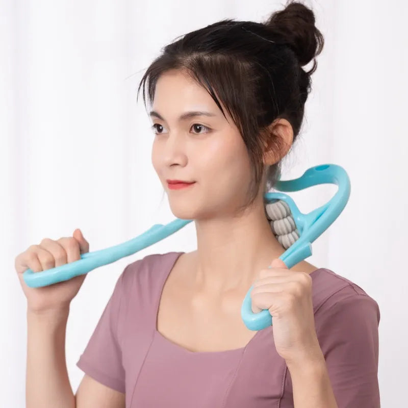 A woman holding a JB Muscle™ Cervical Spine Massager 6 Wheel Portable Neck Massager in her hands, helping her unwind and rejuvenate.