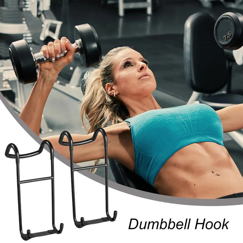 A woman in a blue top lifts a dumbbell on a bench at the gym, demonstrating her dedication to strength training. Next to her are JB Muscle's 2pcs Dumbbell Spotter Hooks Hanger Barbell Dumbbells Rack Attachments for Dumbbell Bench Press, essential for safety and efficiency with their ability to hold up to 225 lbs.