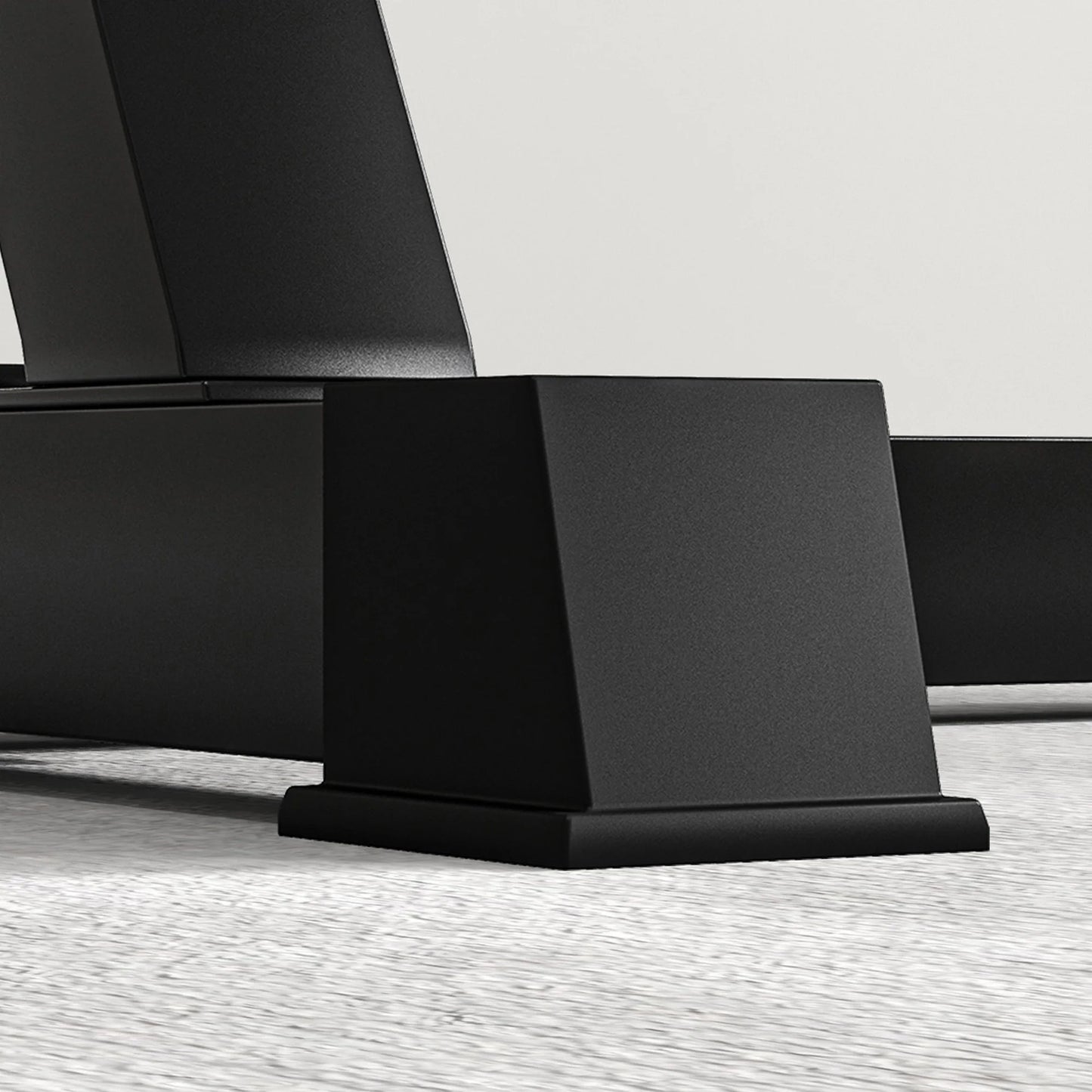 A close-up view of the black base of the JB Muscle SPORTNOW Adjustable Preacher Curl Bench, a multi-functional weight bench with handlebar and elbow cushion, on a light textured floor for home or outdoor gym use.